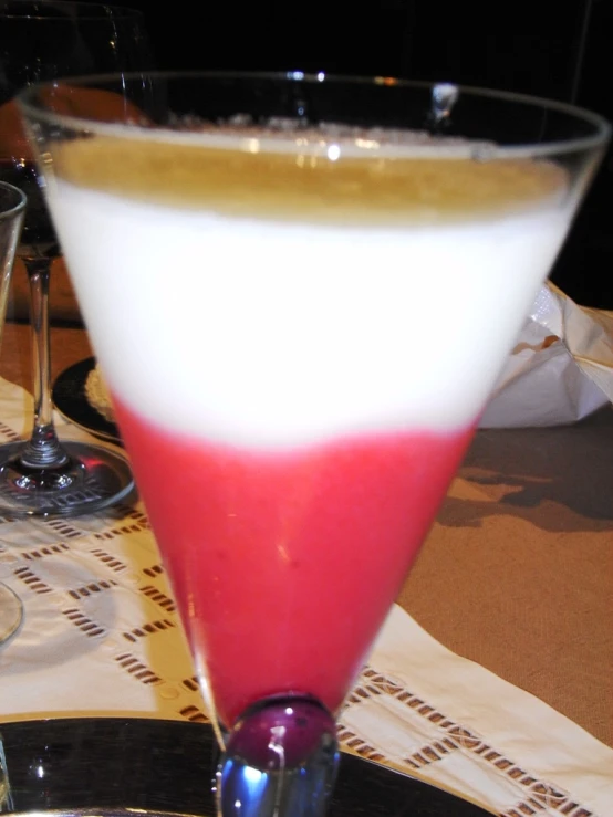 a red, white and blue drink is on a plate