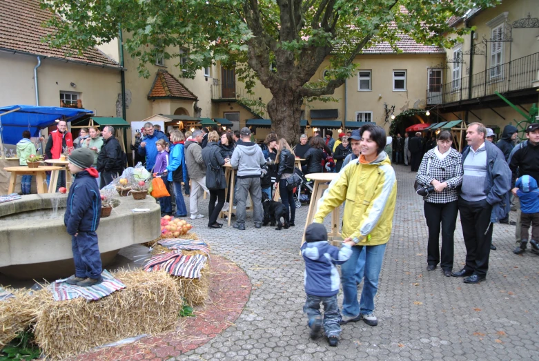 a crowd of people gather outside of buildings