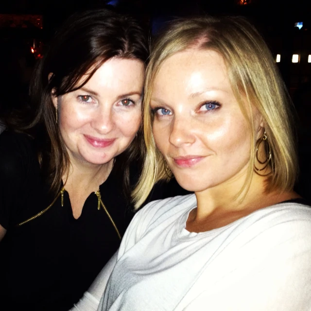 two beautiful blonde women with large round earrings on their heads