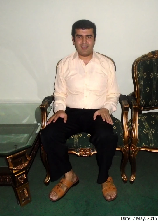 a man sitting in a chair next to a couple of chairs