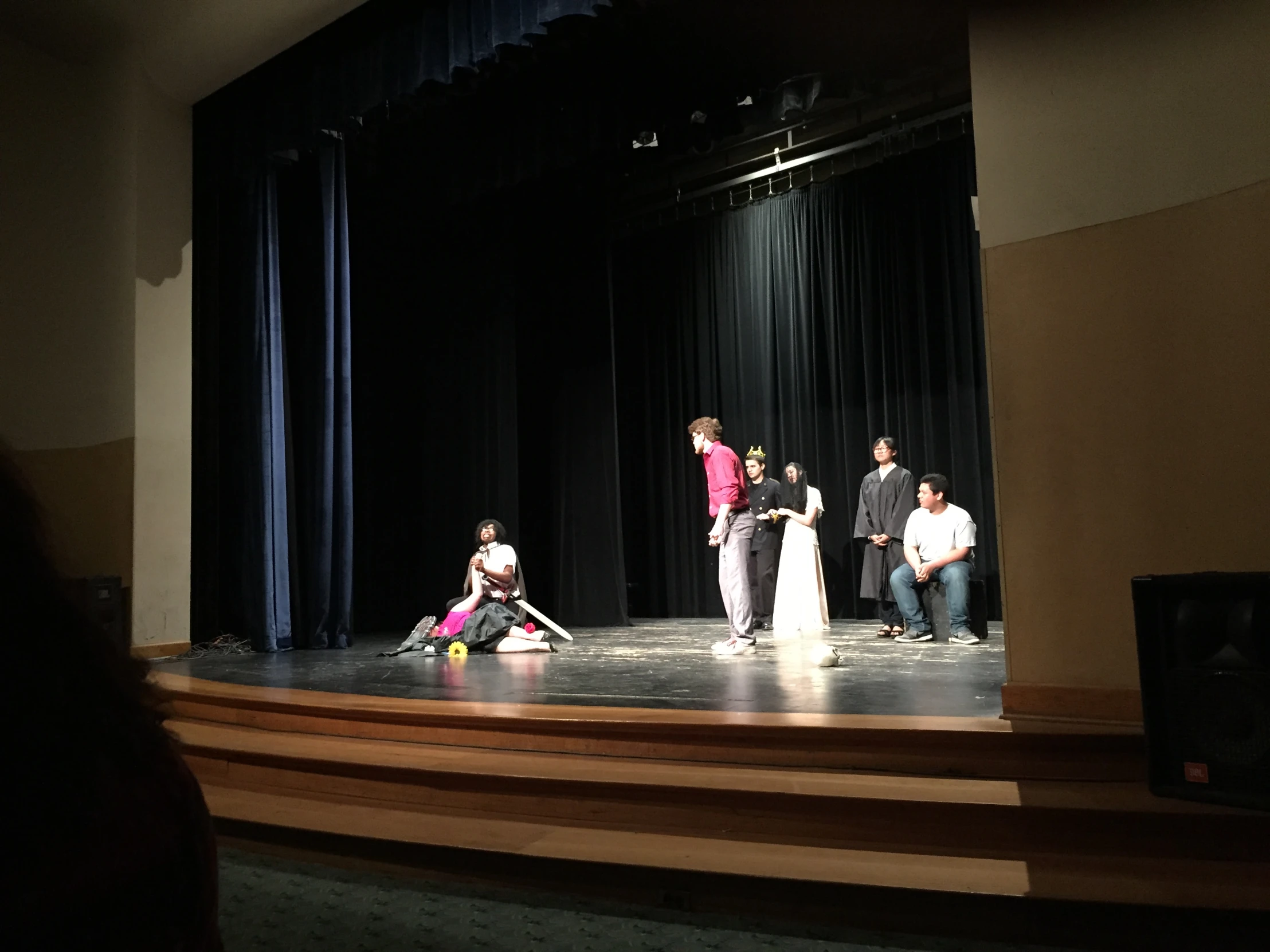 a stage setting with the three actors performing