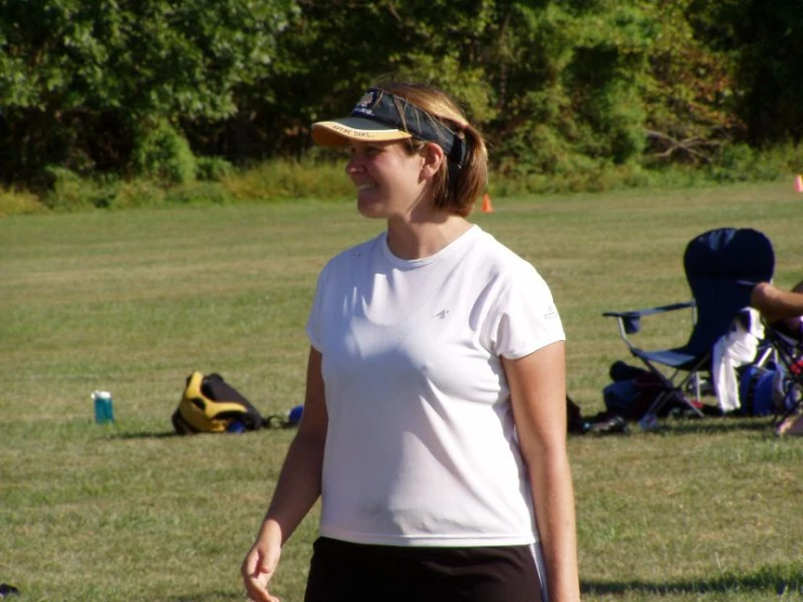 a woman in white shirt standing next to a man in yellow shirt and blue pants