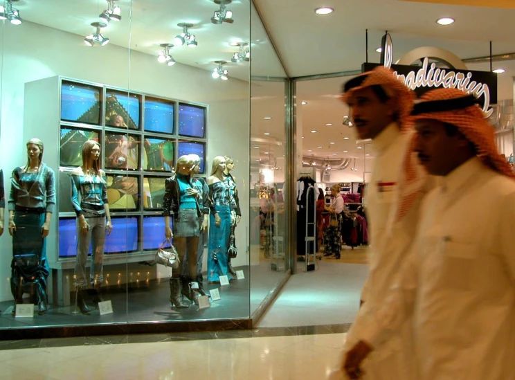 some men standing next to each other in front of a store