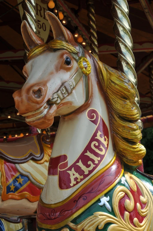 a carousel horse has a happy birthday sign on it
