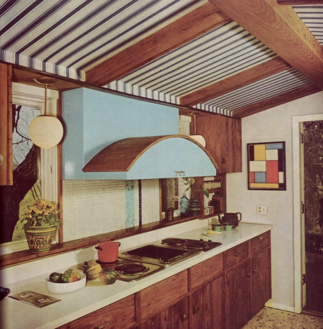 an old kitchen with blue cabinets and a brown stove