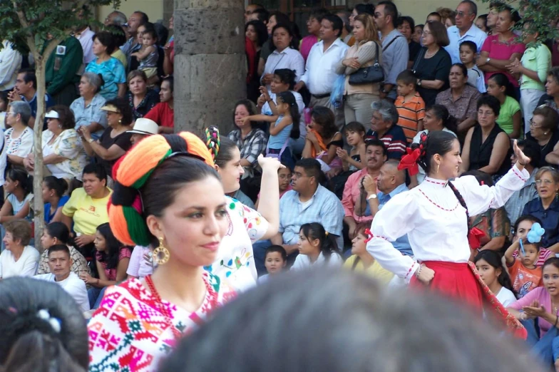 a woman walking in front of a large group of people