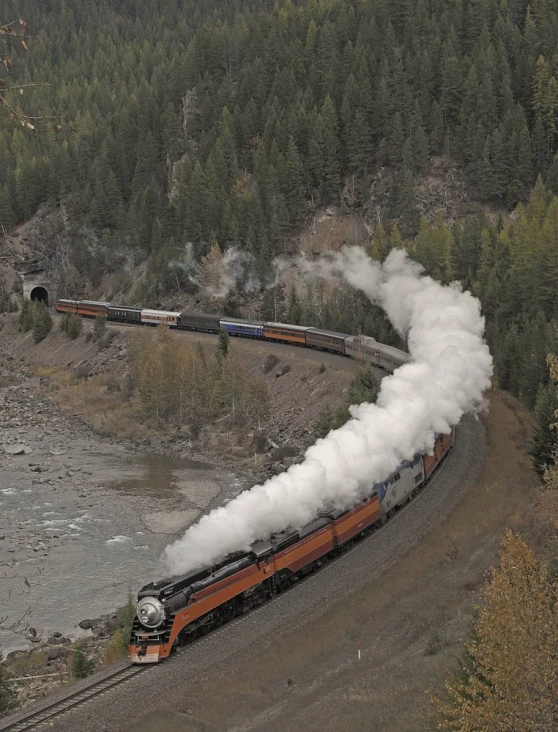 a train going down the tracks with smoke billowing out