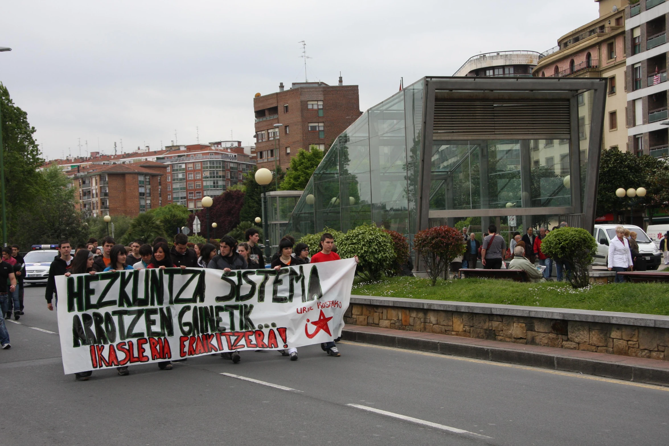 people holding up a banner and standing in the road