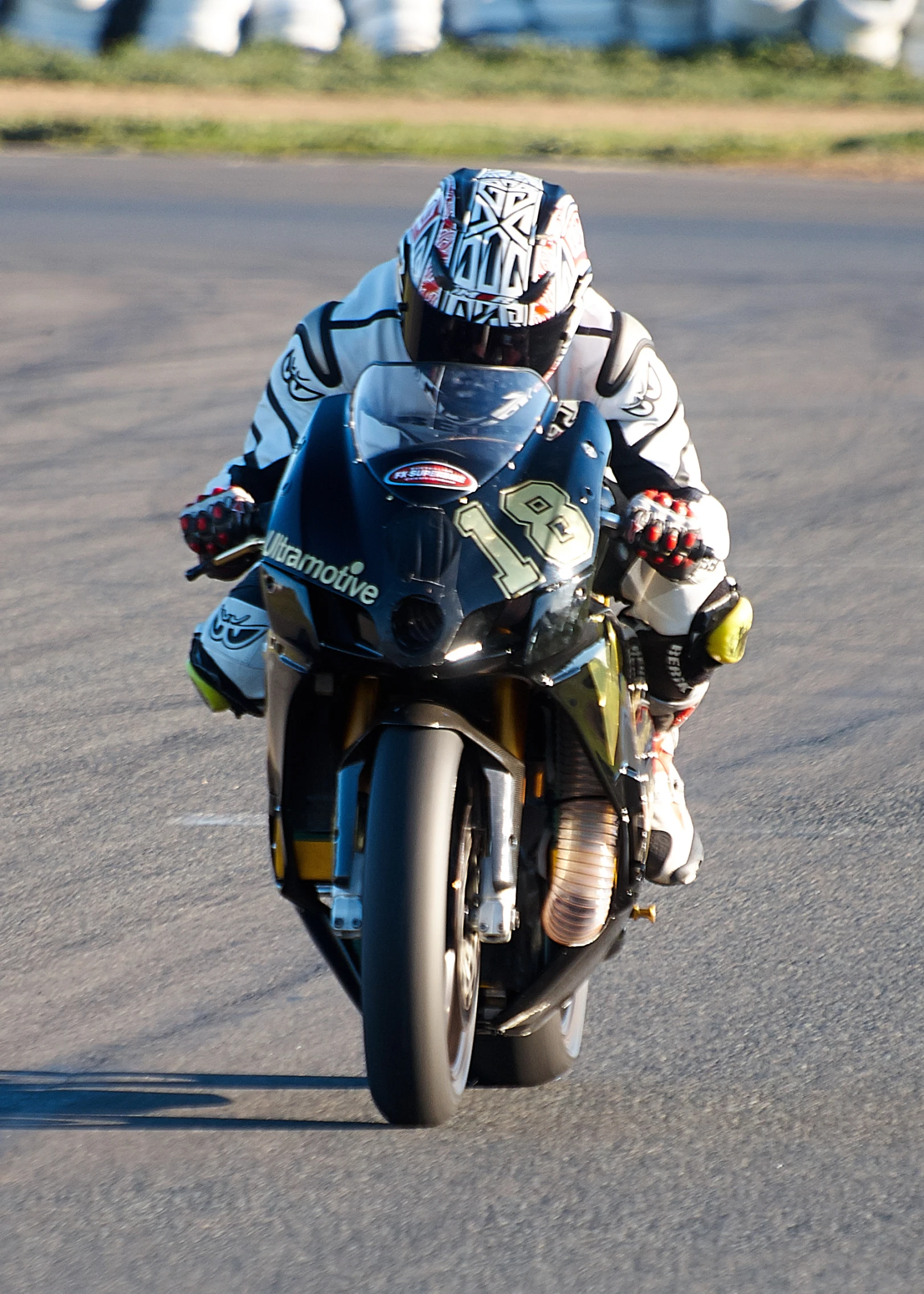 a person on a motorcycle with a helmet on taking a turn