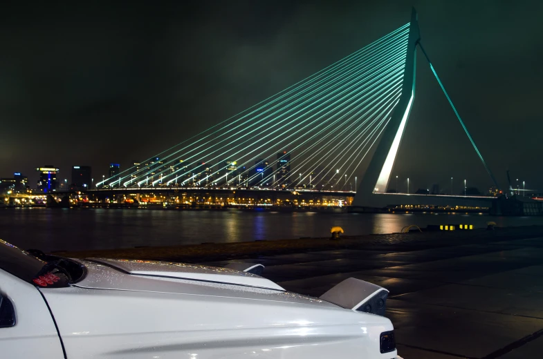 night time view of the new bridge from the shore of a river