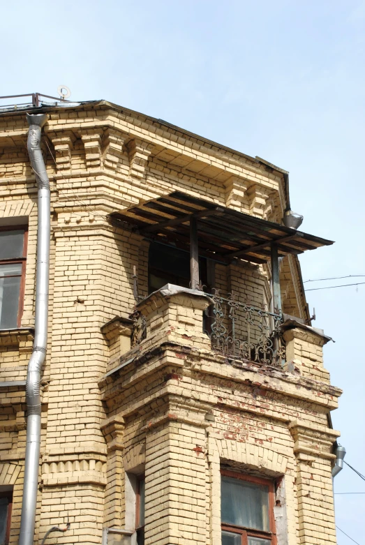 a window on a building has iron rods hanging out the top