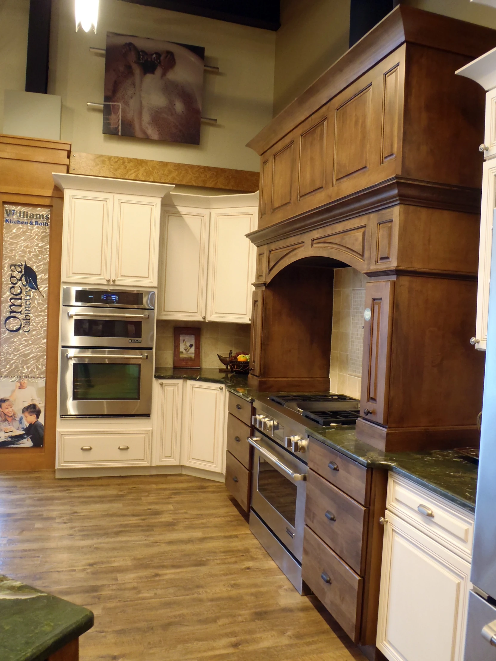 an elegant and large kitchen features white painted cabinets and brown counters