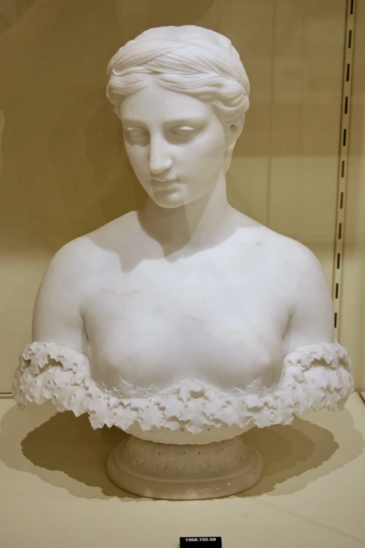 white busturine wearing a lacy white blouse on display