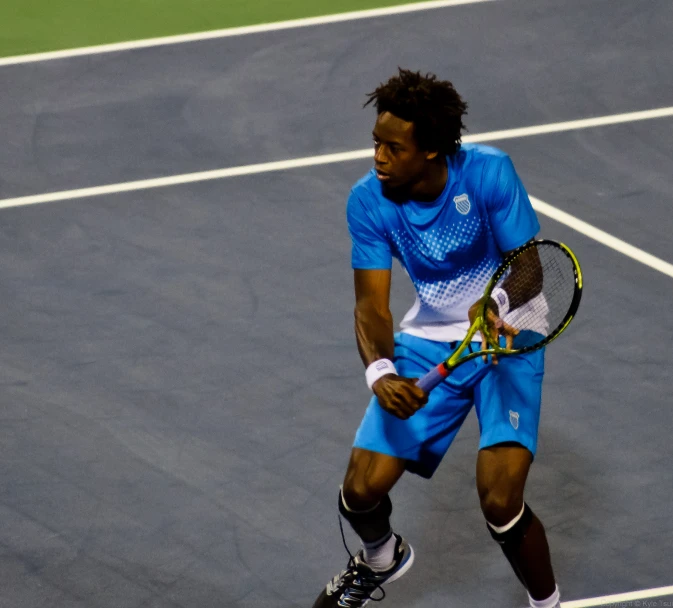 a man is walking on a tennis court with his racket