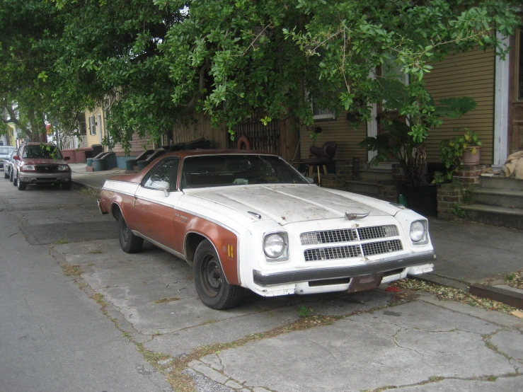 two old cars that are on the street