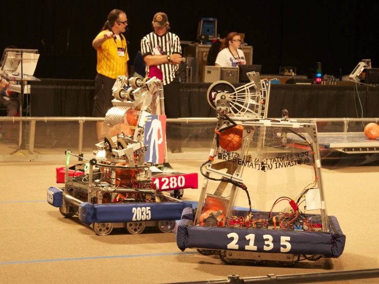 two robot enthusiasts standing next to each other