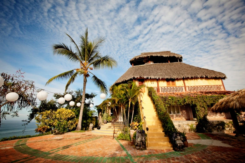 a beach house is situated in the palm trees