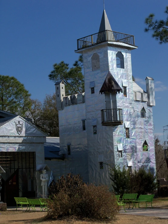 a large church like structure is white with black roofs