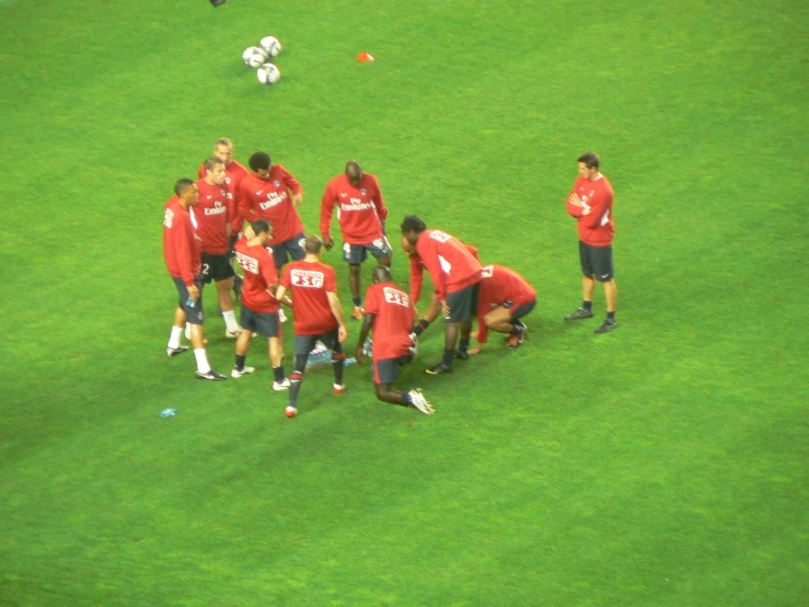 a group of young men are on the soccer field