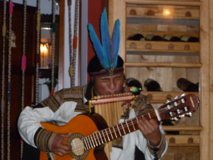 a person holding an instrument and playing the guitar