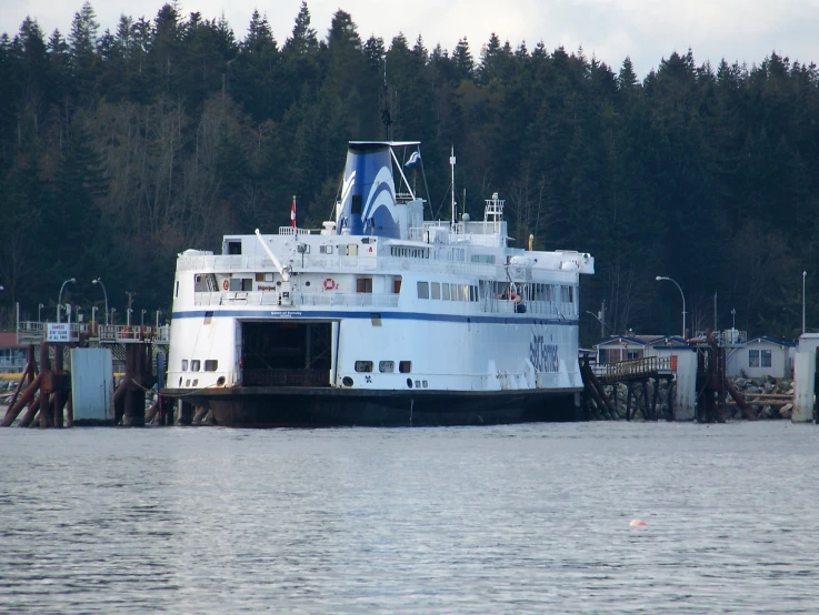 a large boat is moored at the pier