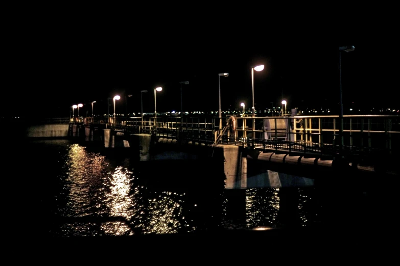 a pier at night is lit up by street lights