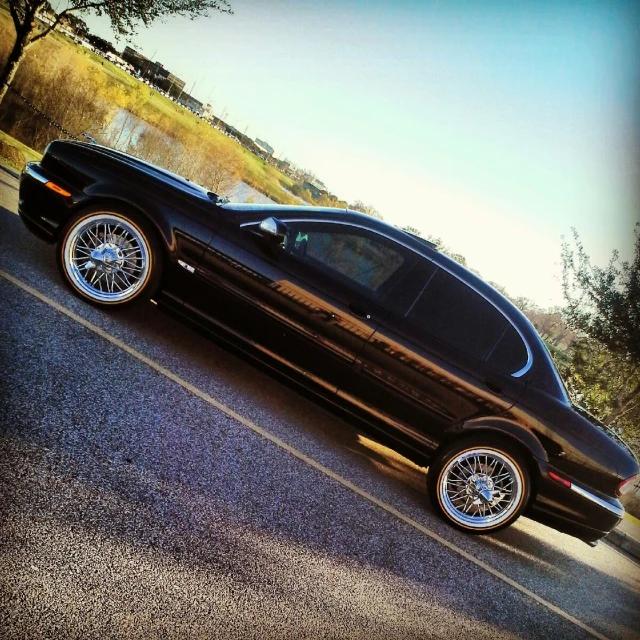 a black car that is parked in the road