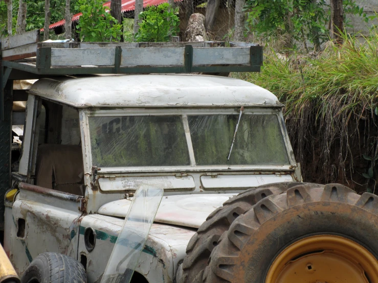 an old white truck with a roof rack on it