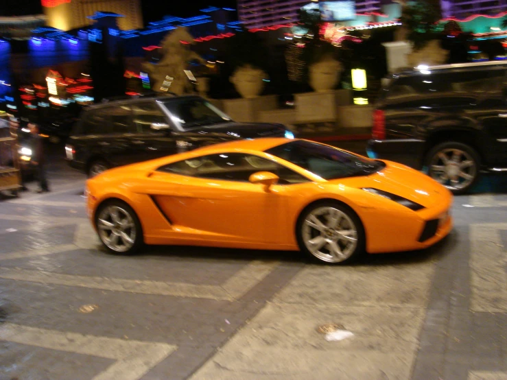 a very nice car parked next to a couple of cars