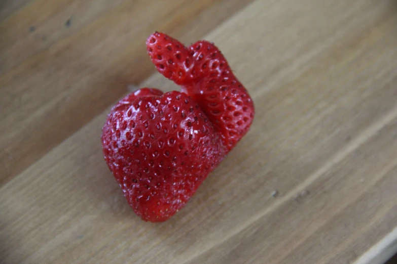 two large strawberries sitting on a table