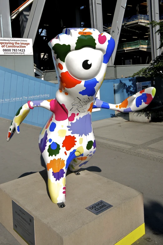 large colorful sculpture of a person and a cat