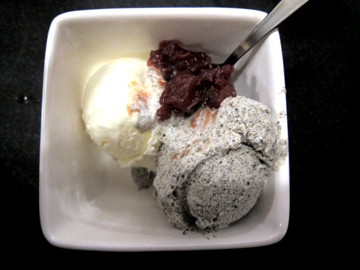 ice cream in a paper bowl with an spoon