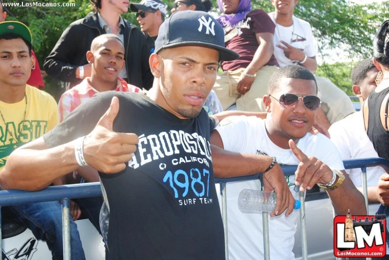 a group of men posing for a picture and giving the thumbs up sign