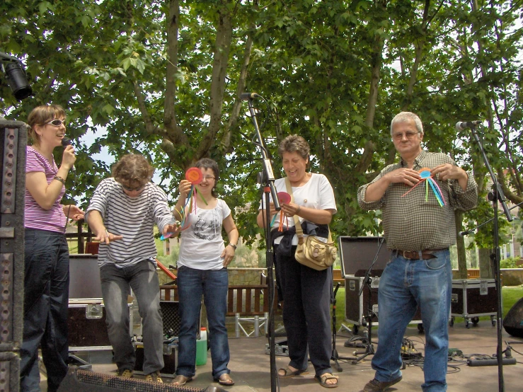 the group is performing at the stage with their instruments