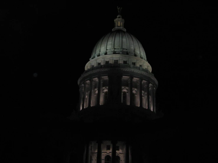 the capitol building at night lit up with lights