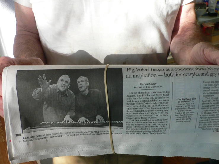 a newspaper showing two men with a newspaper clipping of the same person