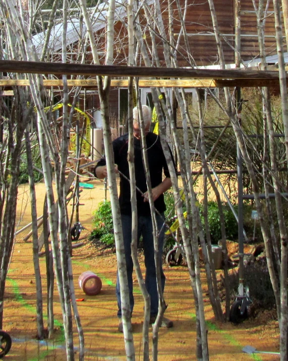 a man playing frisbee in the garden among trees