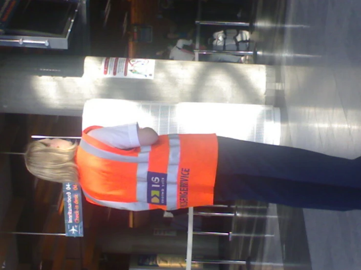 an orange construction vest and hardhat are on a mannequin