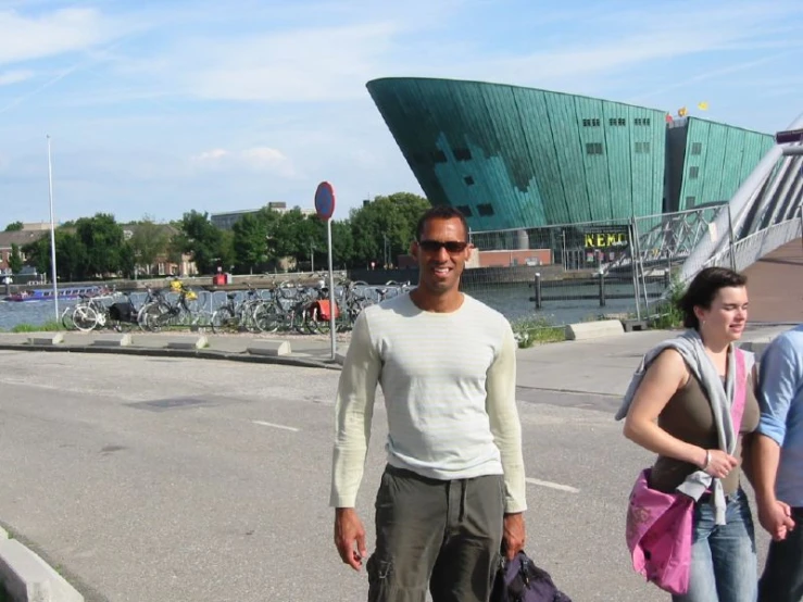 a man standing with his bag on the street