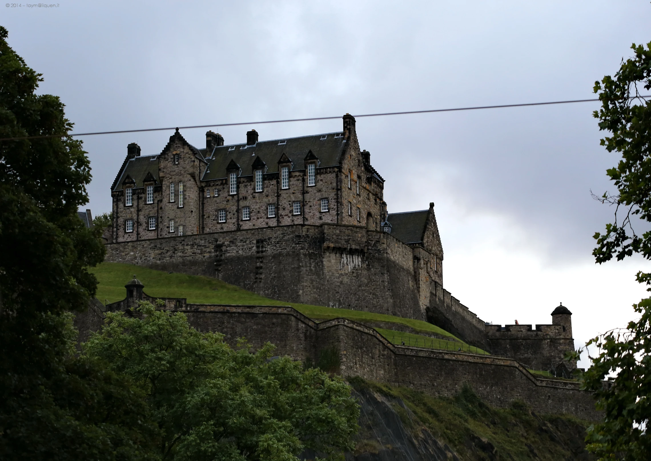 an old building sitting on top of a hill