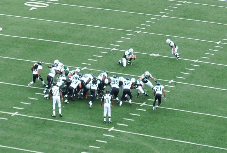 several american football teams are huddled together on the field