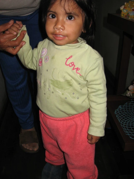 a young child looking to her left with a blurry background