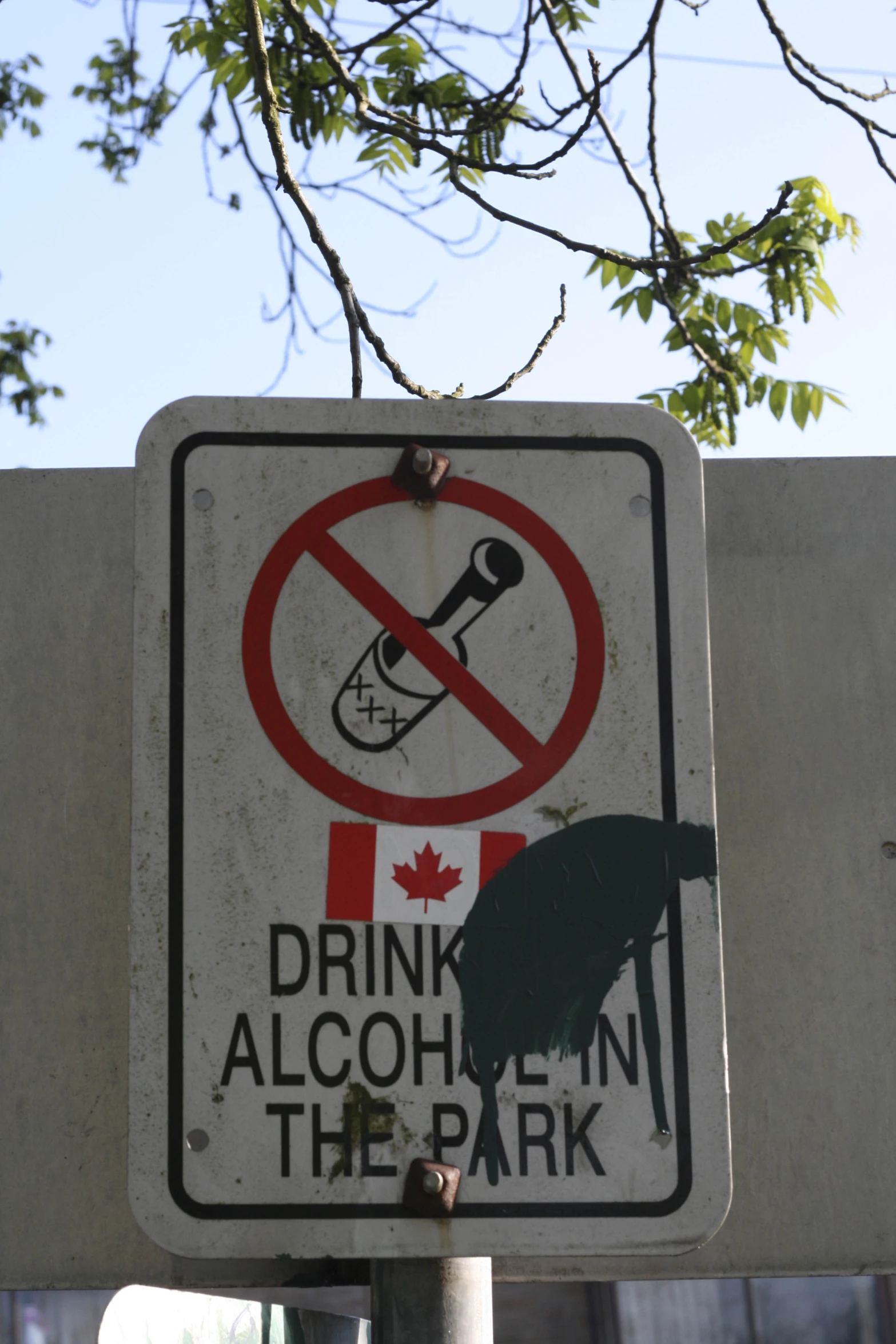 a no smoking sign sitting above a broken drink sign