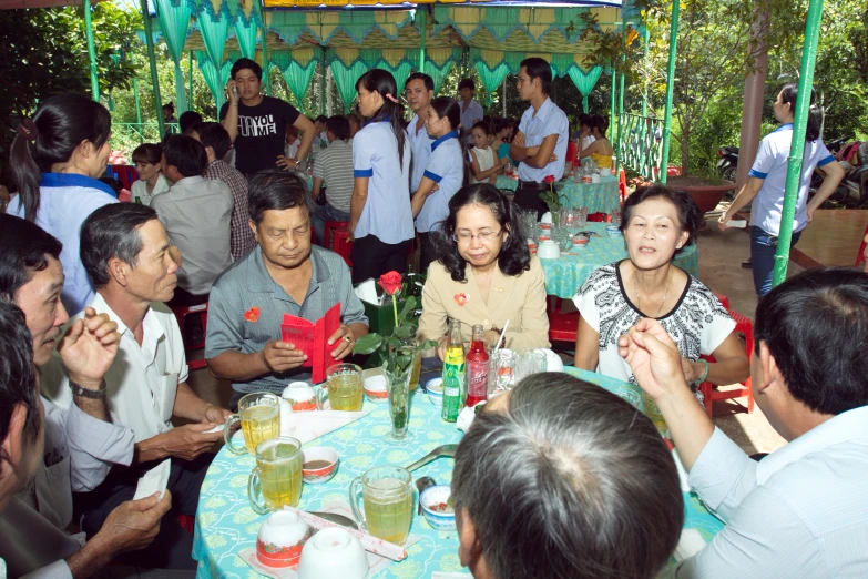 a group of people enjoying a lunch at a garden