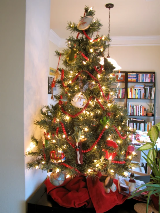 a small christmas tree decorated with ornaments in the living room