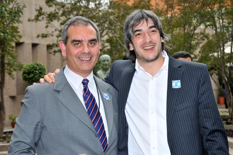 two men in suits standing near each other