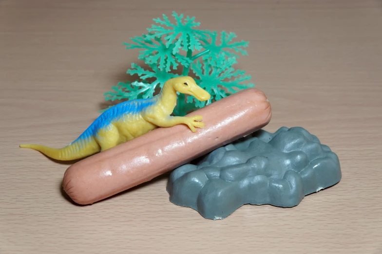 toy plastic dinosaurs with a small  dog