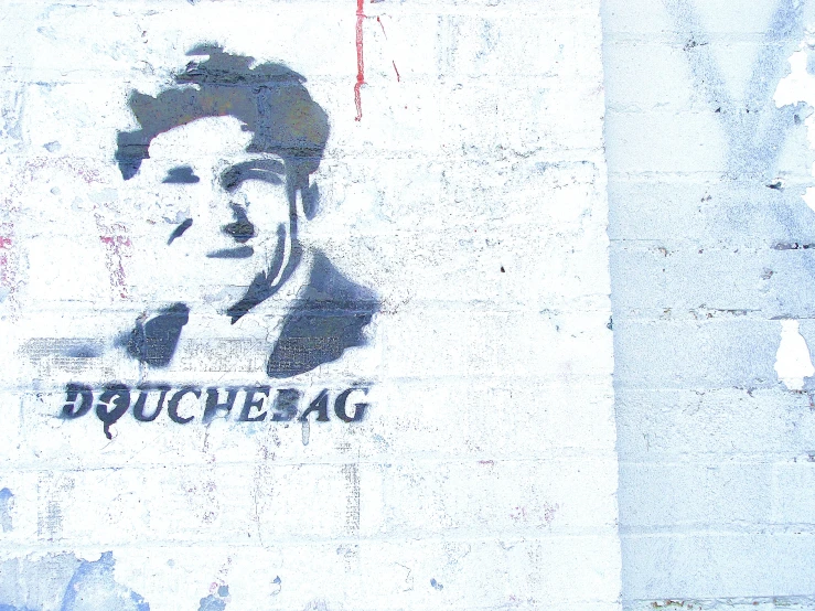 a stencil depicting a man's face painted on concrete