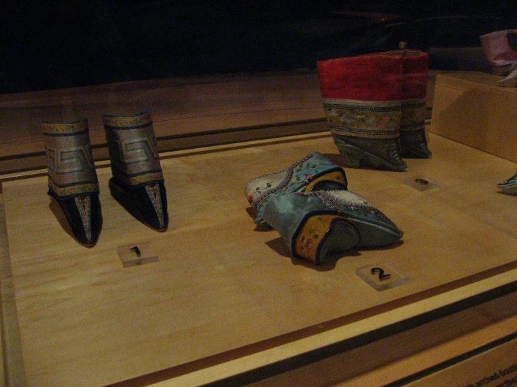 several pairs of shoes are on display at a museum