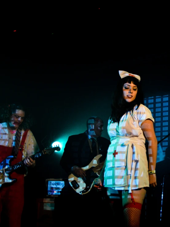 a woman standing on stage with a bandleader behind her